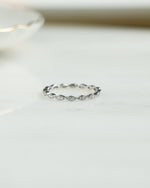 Front view of Sami Jewels diamond stacking ring in sterling silver, featuring multiple delicate bands with sparkling diamonds.