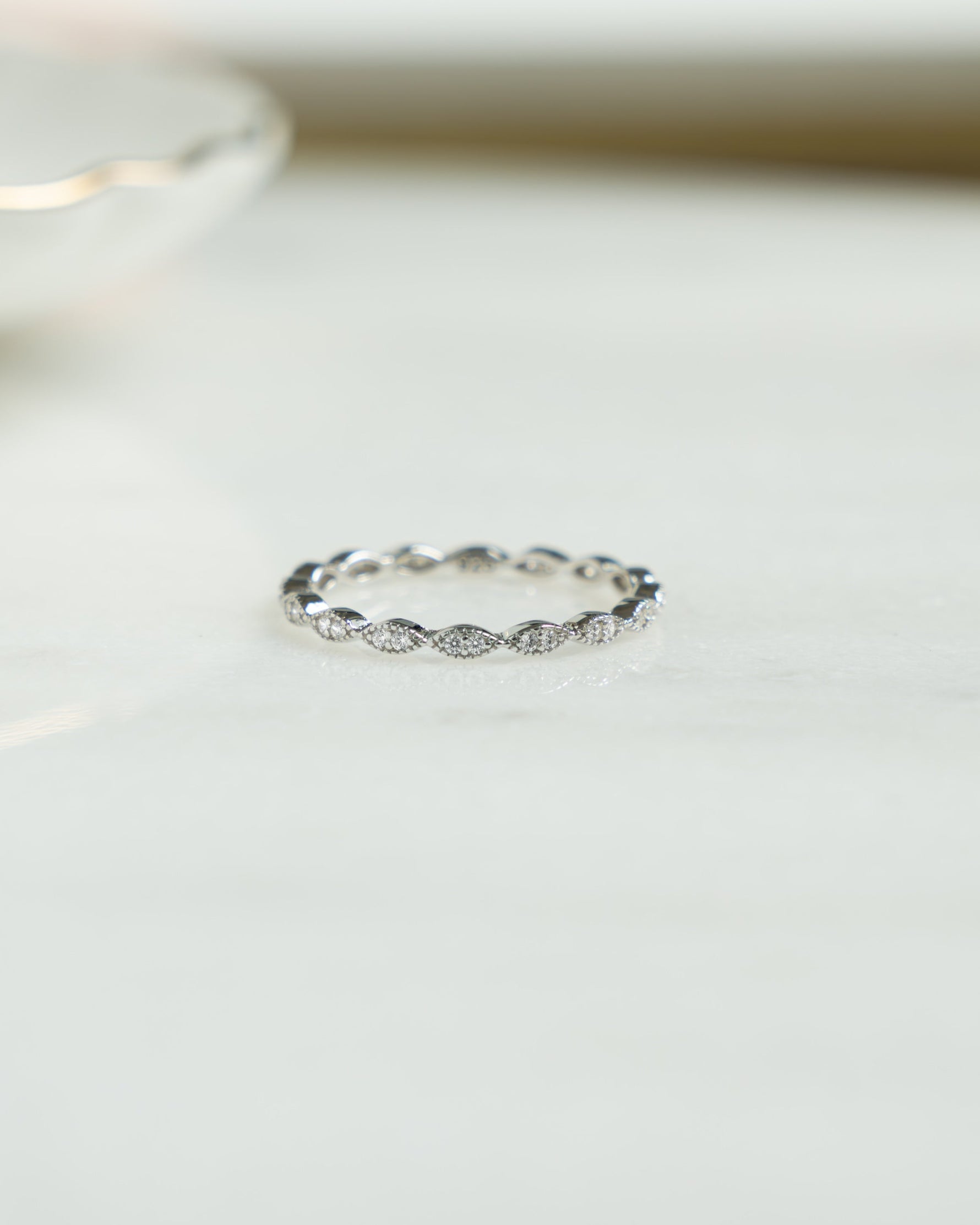 Front view of Sami Jewels diamond stacking ring in sterling silver, featuring multiple delicate bands with sparkling diamonds.