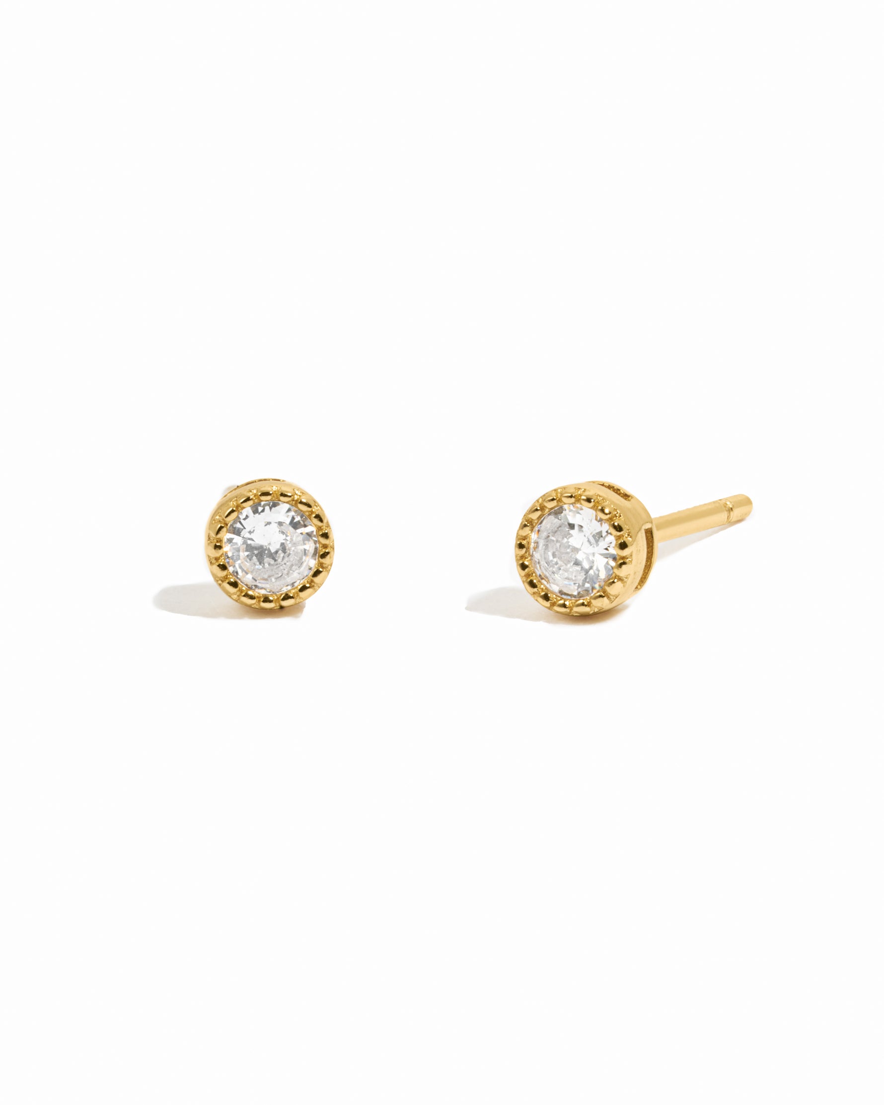 gold diamond stud earrings white background