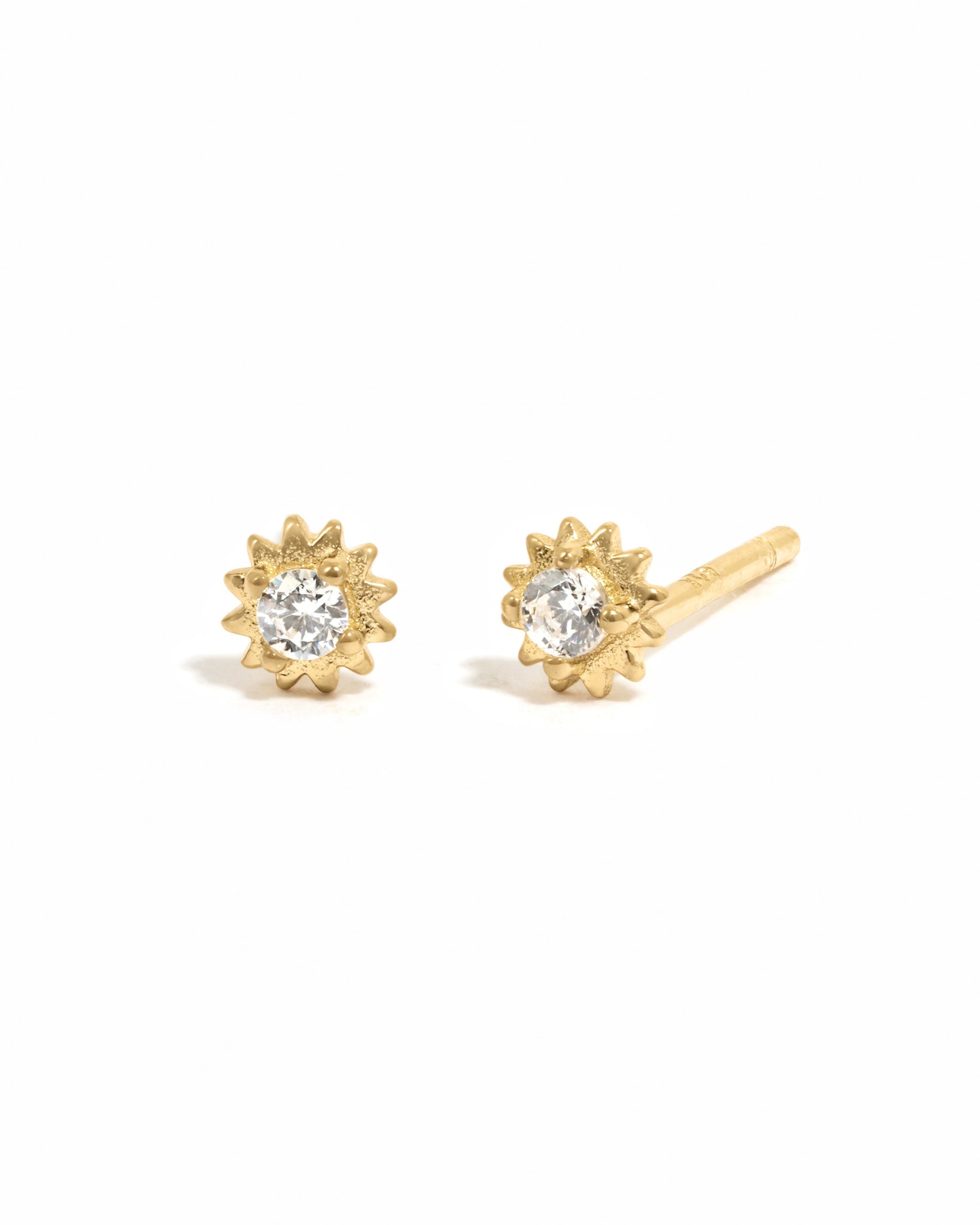 Gold CZ Tiny Sunburst Stud Earrings by Sami Jewels with diamond-shaped sunburst design on a white background