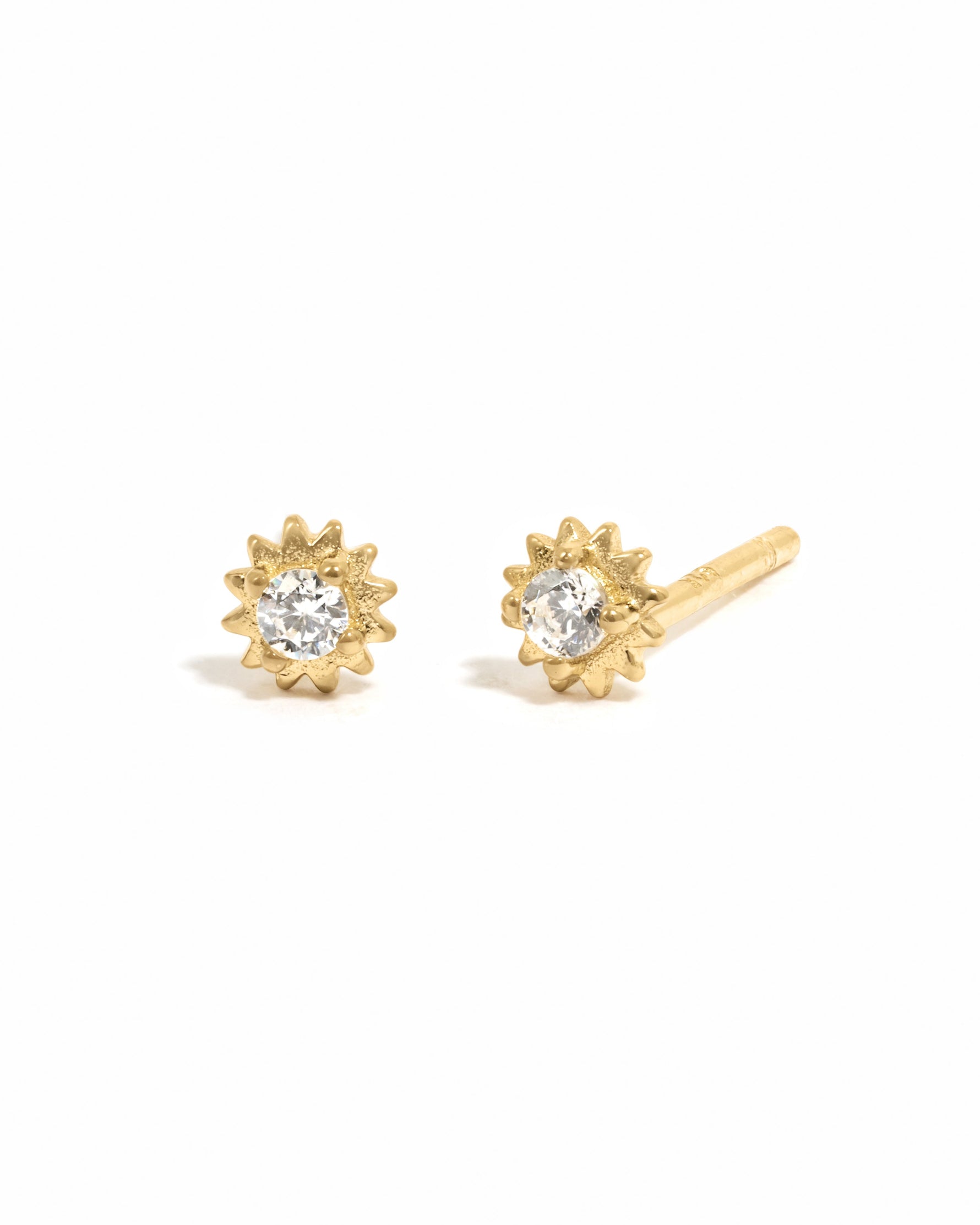Gold CZ Tiny Sunburst Stud Earrings by Sami Jewels with diamond-shaped sunburst design on a white background
