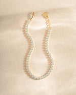 Gold 3mm round tennis bracelet by Sami Jewels featuring sparkling diamond accents, viewed from the top showing its elegant design.