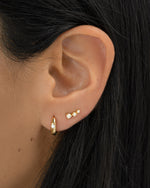 Gold Dome Diamond Huggie Earrings by Sami Jewels featuring sparkling diamonds and a sleek, rounded design.