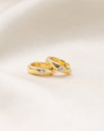 Gold Dome Diamond Huggie Earrings by Sami Jewels, side profile view showing smooth dome design with embedded diamonds.