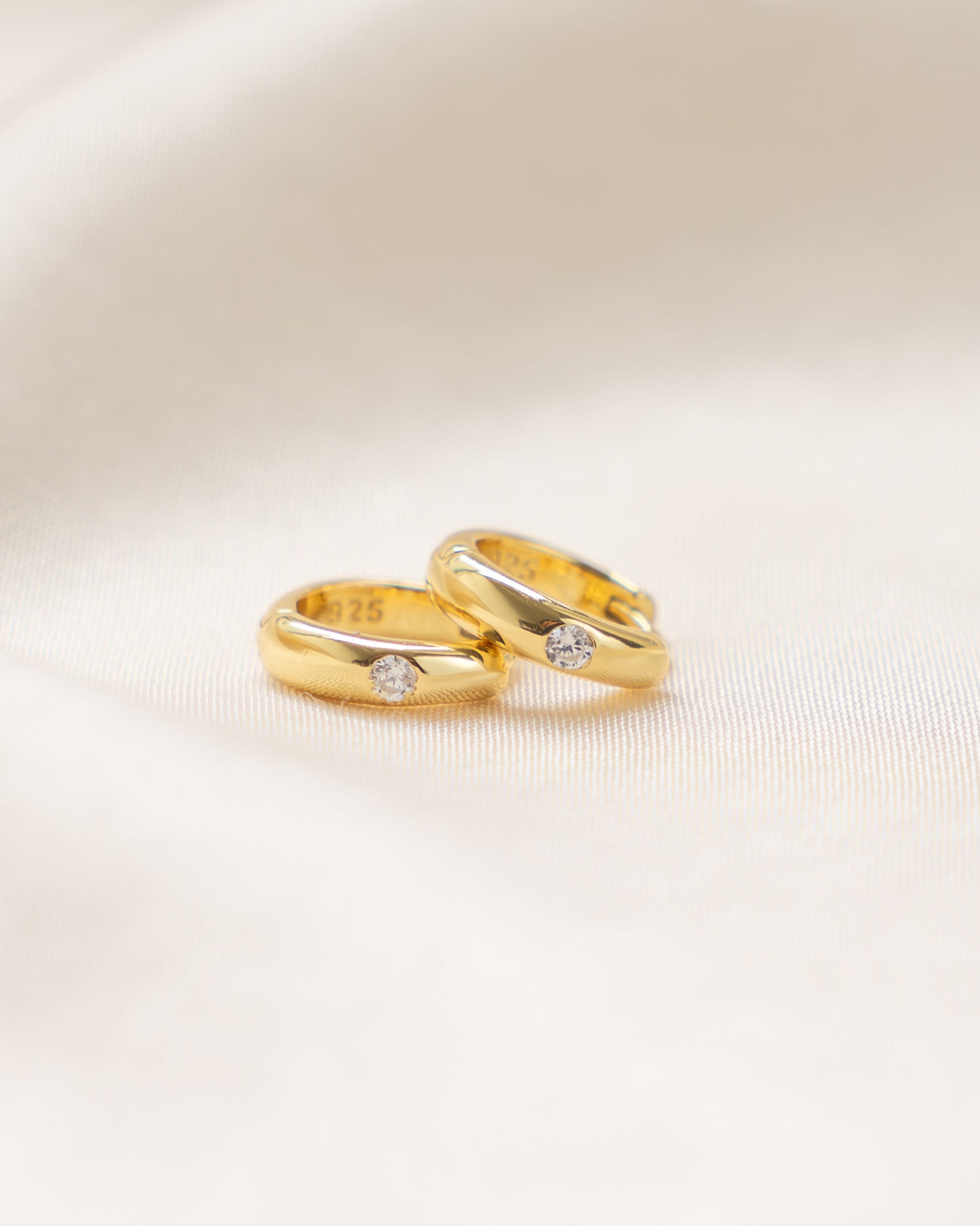Gold Dome Diamond Huggie Earrings by Sami Jewels, side profile view showing smooth dome design with embedded diamonds.
