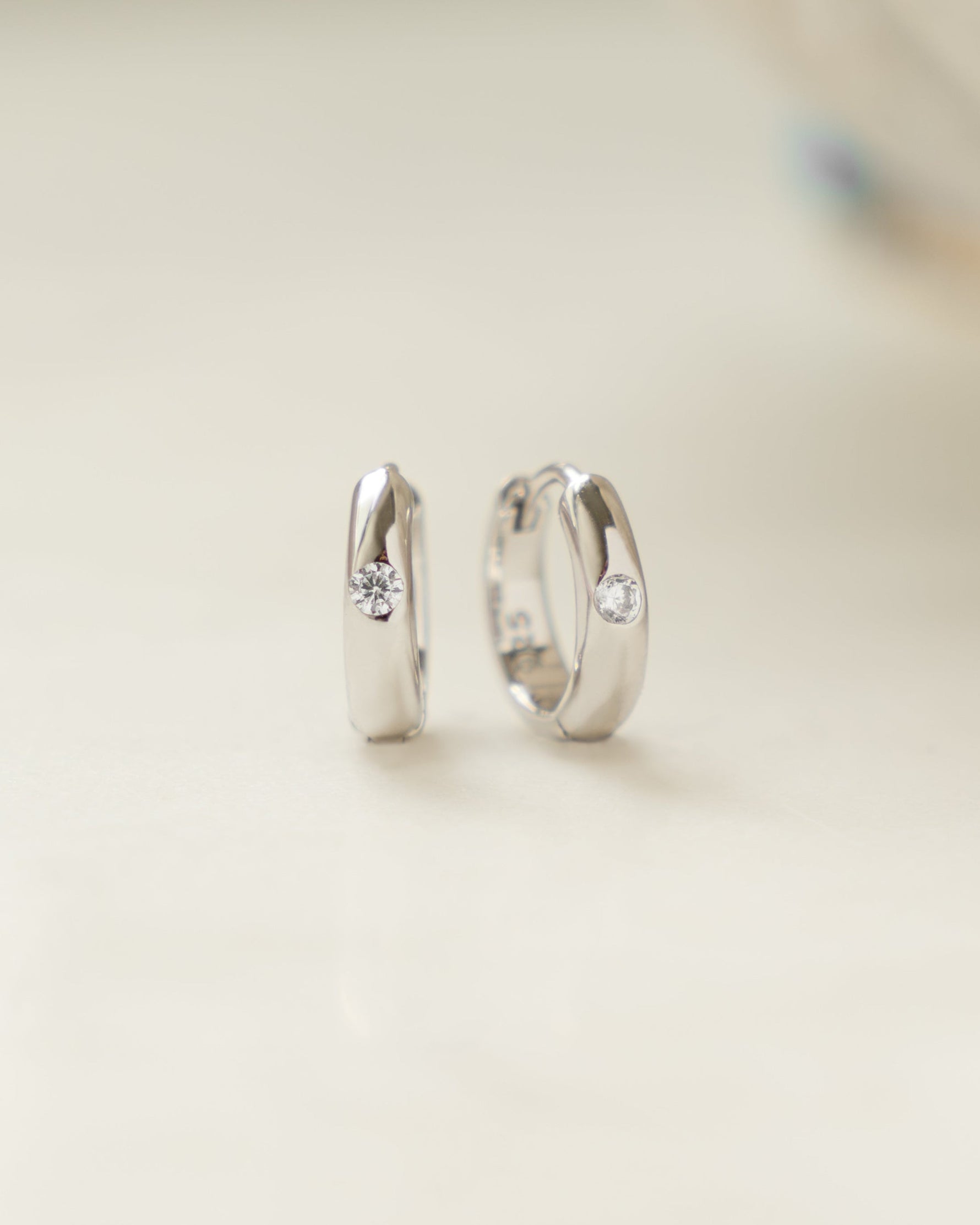 Sterling silver Dome Diamond Huggies earrings featuring small sparkling diamonds and a sleek, rounded design by Sami Jewels.