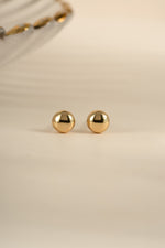 Gold Dot Stud Earrings by Sami Jewels showing a front view of small, round gold stud earrings on a white background.