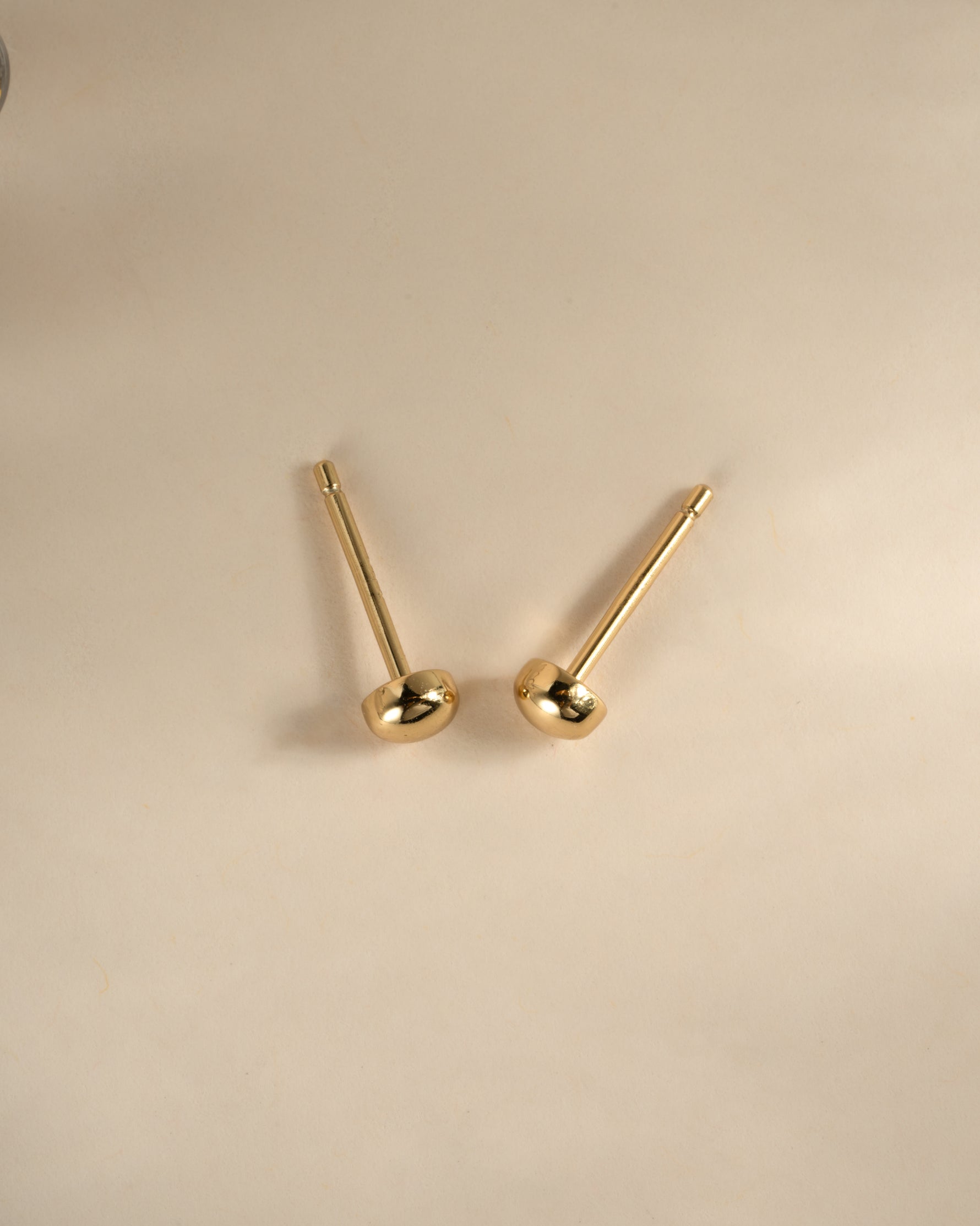 Gold Dot Stud Earrings by Sami Jewels, top view showing small circular stud design in shiny gold finish.