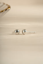 Sterling silver dot stud earrings by Sami Jewels featuring small, minimalist round design for everyday wear.