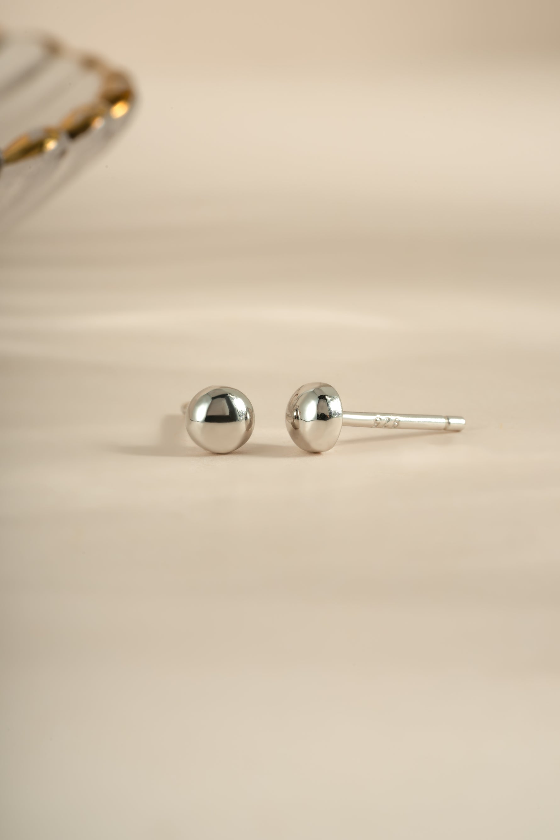 Sterling silver dot stud earrings by Sami Jewels featuring small, minimalist round design for everyday wear.