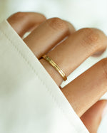 Gold double band ring by Sami Jewels featuring sleek, intertwined bands in a stylish jewelry design.