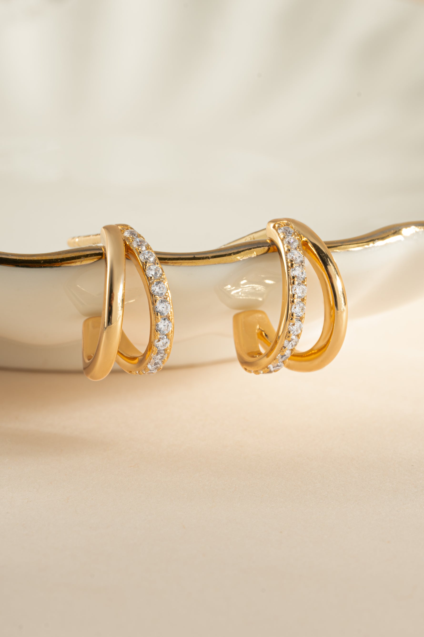 Gold double diamond hoop earrings by Sami Jewels, showcasing elegant and sparkling jewelry design with intricate diamond details.