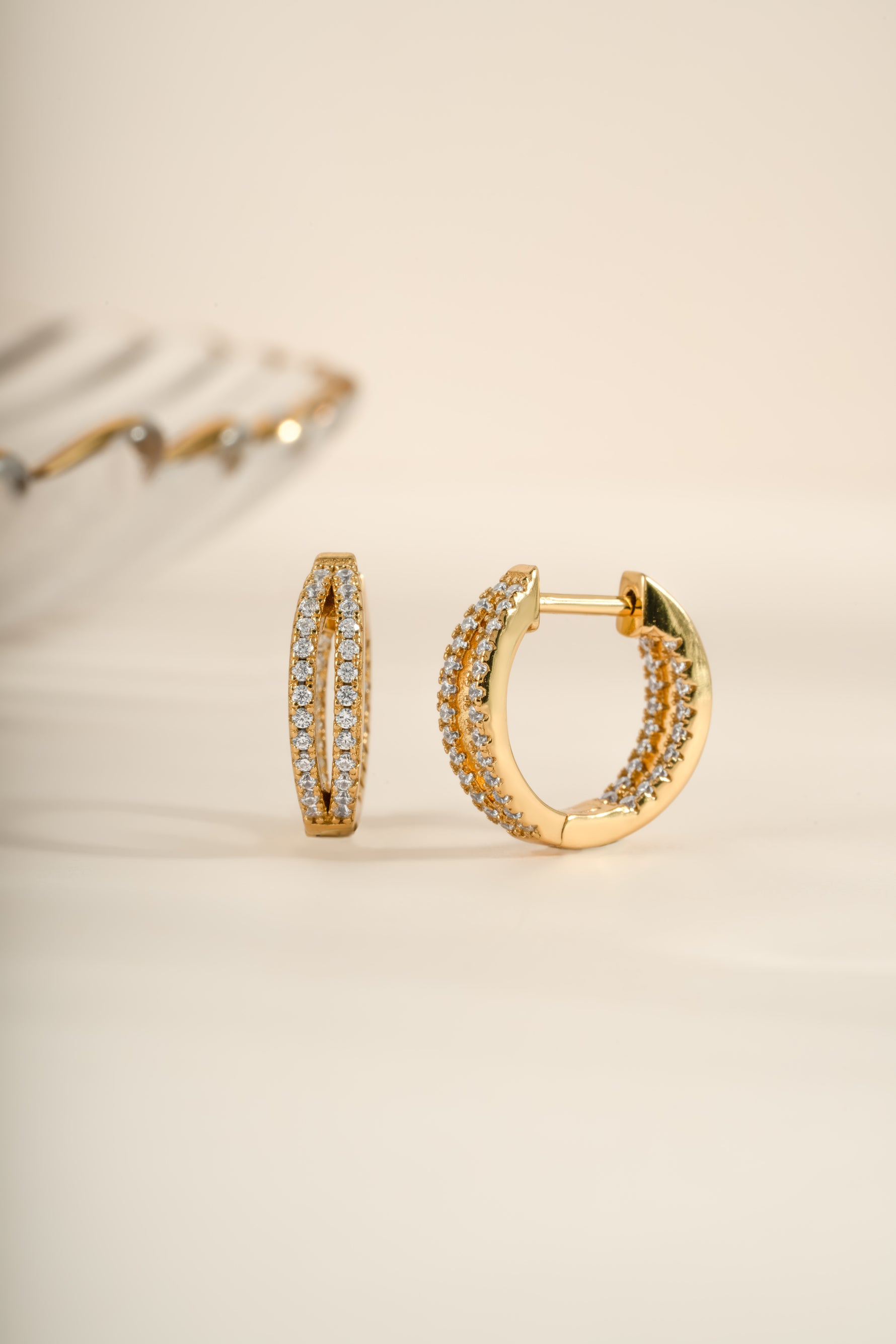 Gold double hoop earrings from Sami Jewels, featuring an angled view of stylish, modern double hoop design.