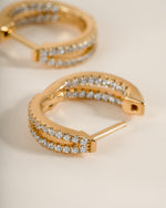 Close-up of gold double hoop earrings from Sami Jewels, showcasing their stylish and shiny design.