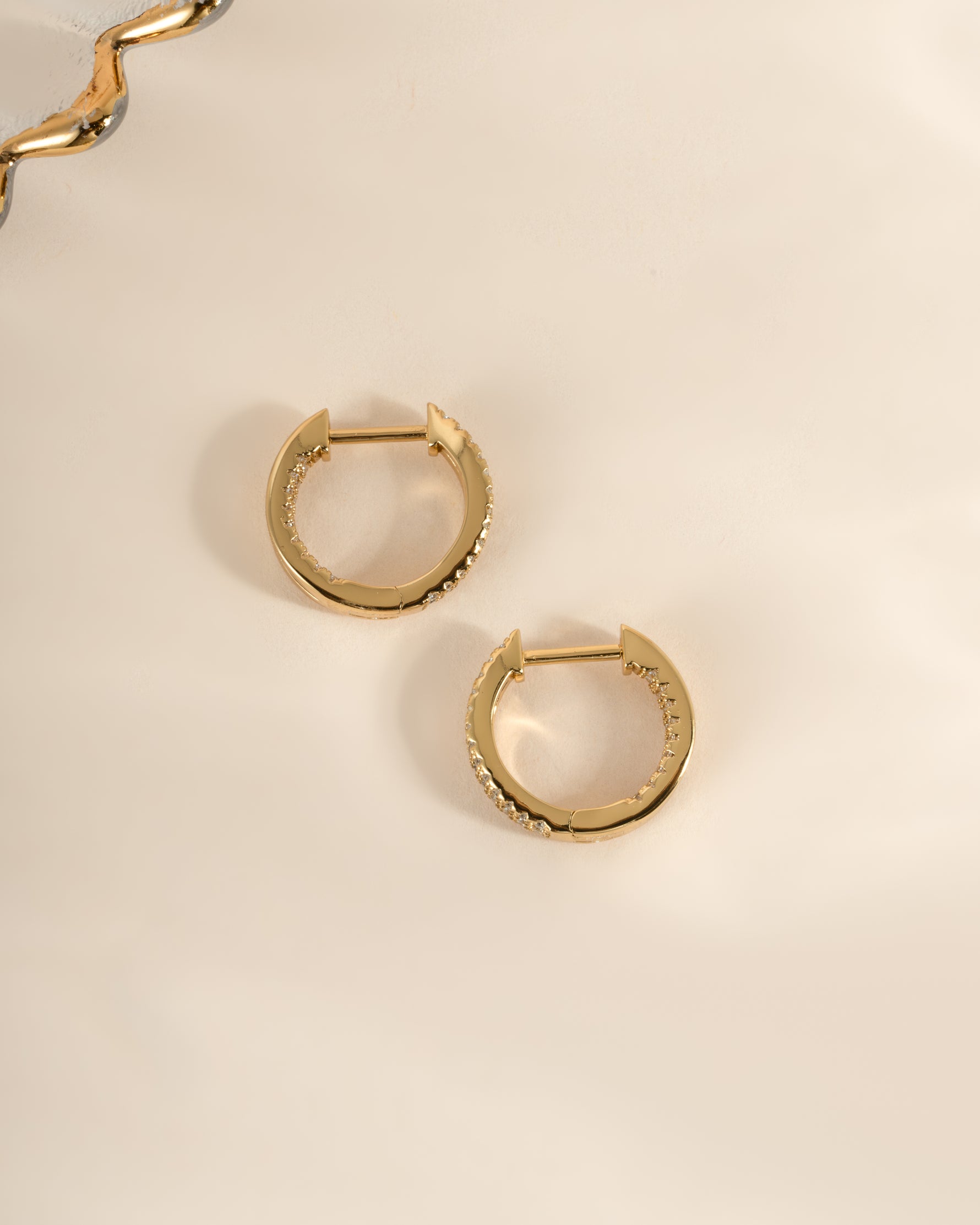 Gold double hoop earrings by Sami Jewels, side profile view showcasing layered design and polished finish.