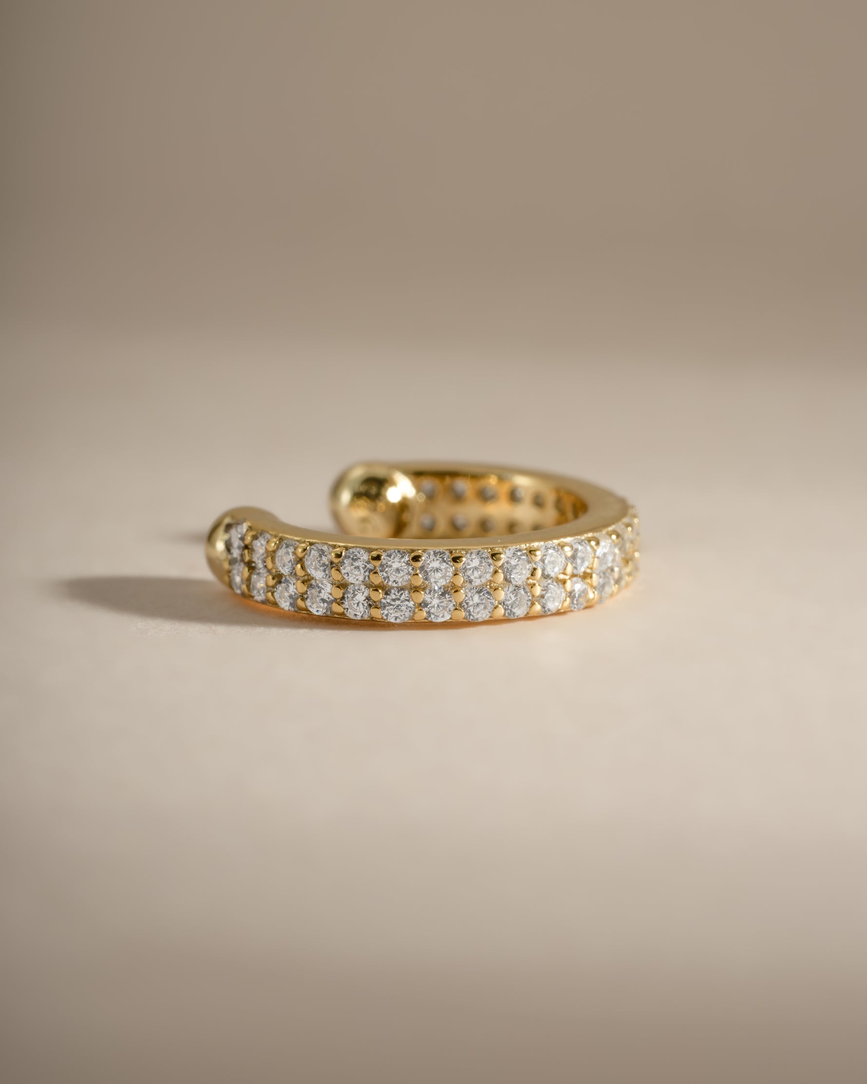 Close-up of Sami Jewels double row CZ ear cuff earrings in gold, showcasing sparkling cubic zirconia stones and modern design.