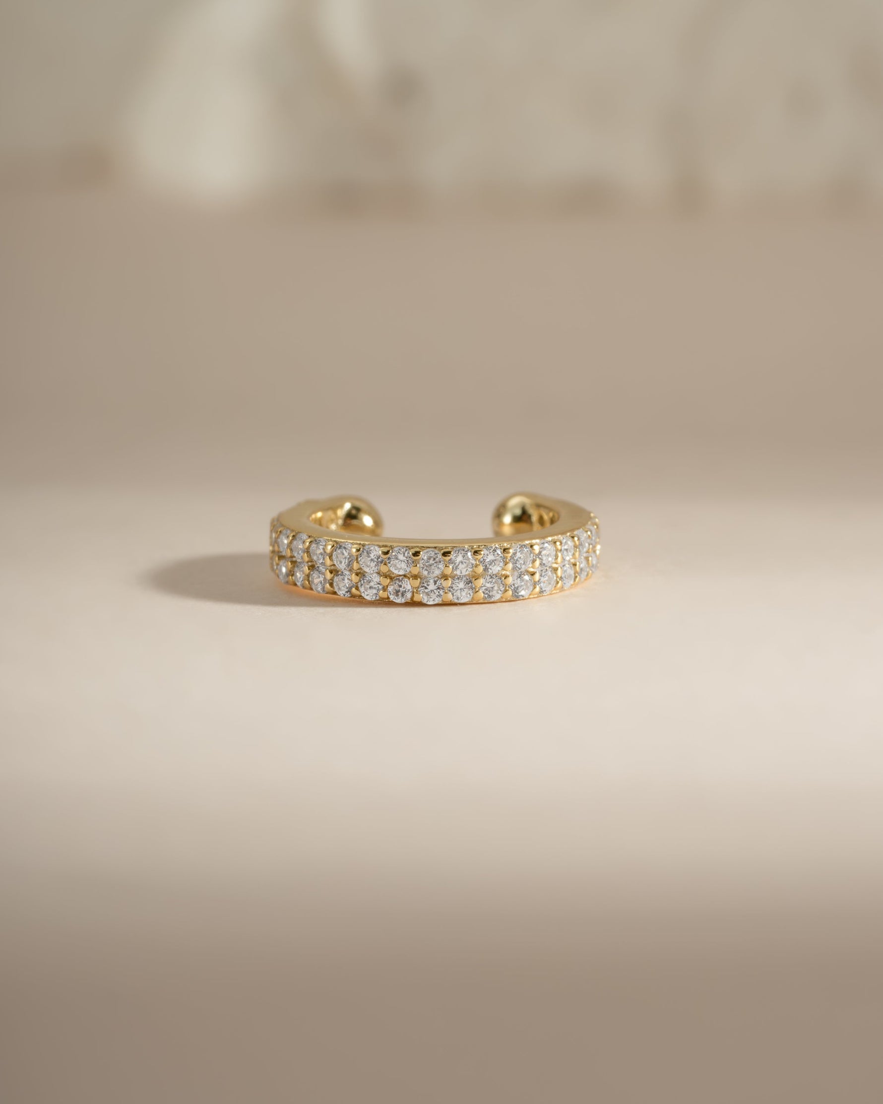 Gold double row CZ ear cuff earrings by Sami Jewels, front view showing sparkling diamond-like stones on the cuff.