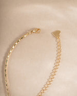 Emerald baguette bezel statement necklace with lobster clasp closure, featuring vibrant green gemstones and elegant jewelry design.