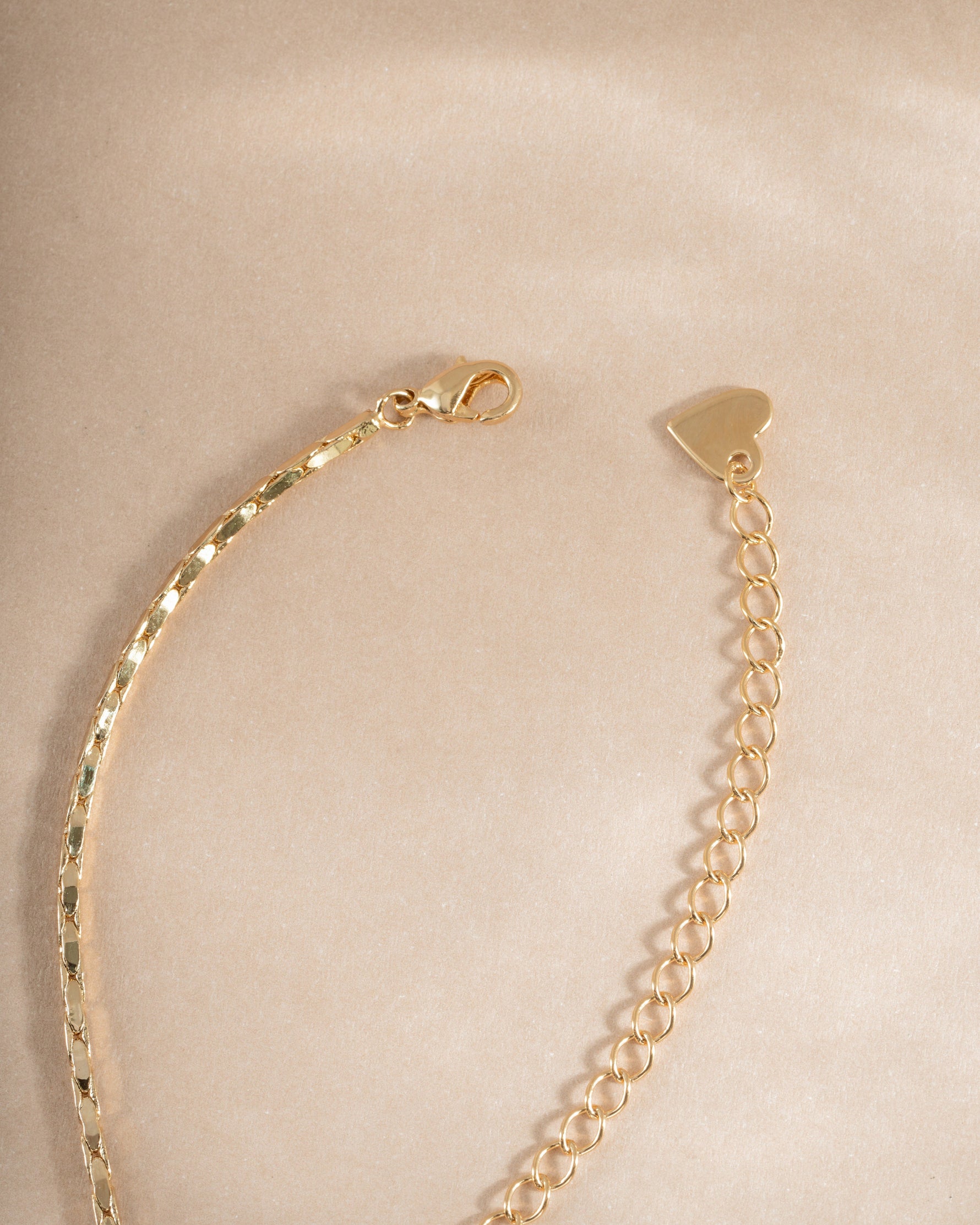 Emerald baguette bezel statement necklace with lobster clasp closure, featuring vibrant green gemstones and elegant jewelry design.