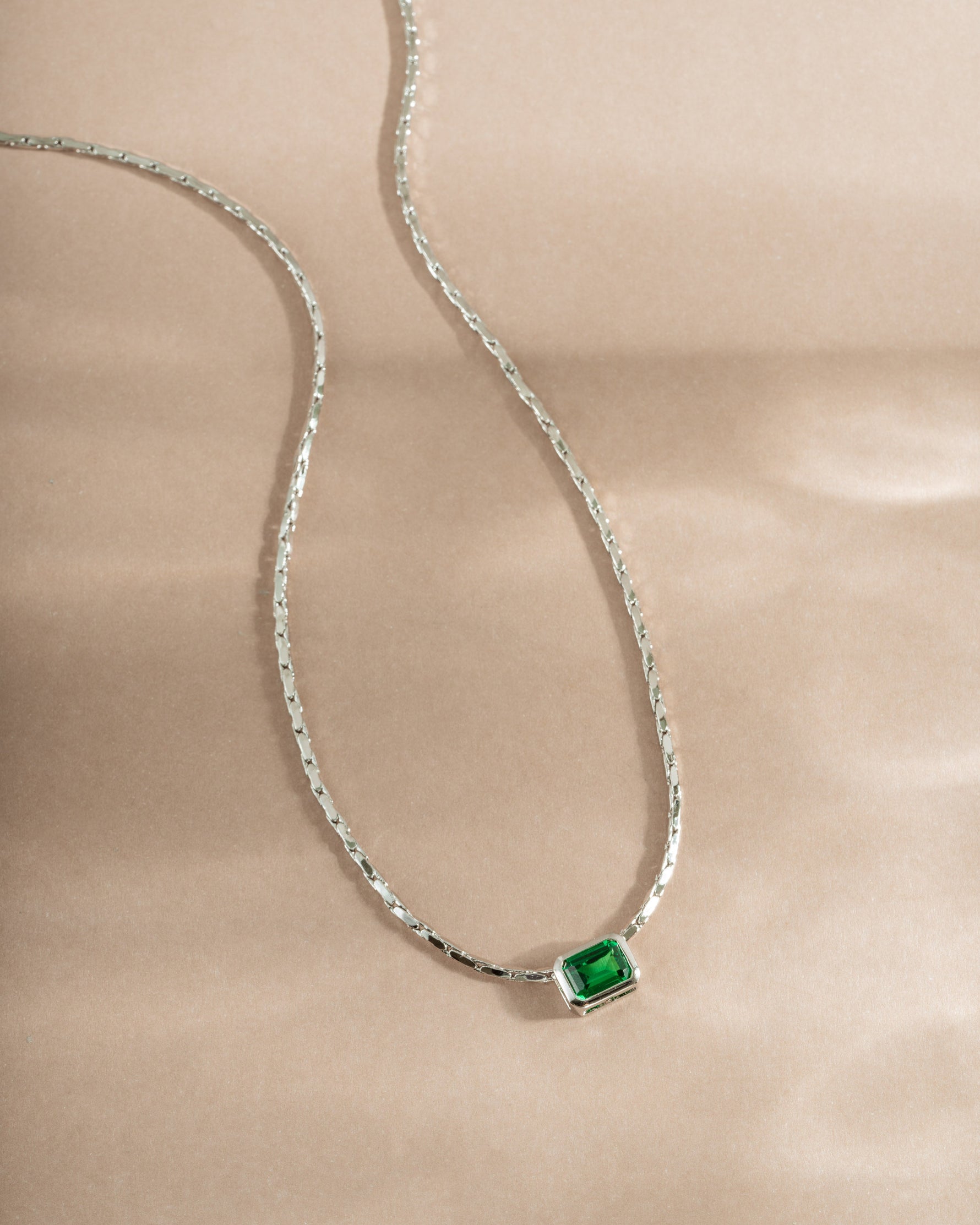 Emerald baguette bezel statement necklace by Samijewels-527 featuring a sterling silver chain and vibrant emerald gemstones.