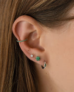 Sterling silver emerald baguette huggie earrings by Sami Jewels featuring sleek, modern design with vibrant green gemstones.