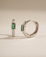 Side view of Sami Jewels emerald baguette huggie earrings in sterling silver, showcasing their sleek design and vibrant green gemstones.