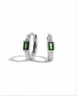 Sterling silver emerald baguette huggie earrings from Sami Jewels, featuring vibrant green rectangular gemstones on a white background.