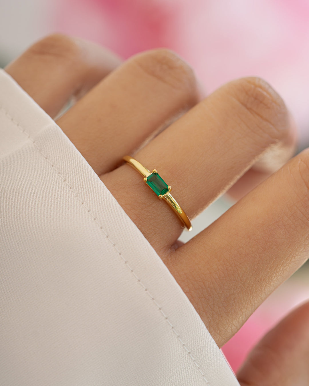 Gold Emerald Lori Baguette Ring by Sami Jewels featuring a striking emerald baguette gemstone set in a sleek gold band.