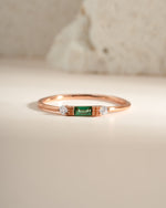Sami Jewels emerald baguette ring with rose gold band featuring a rectangular emerald gemstone and elegant design.