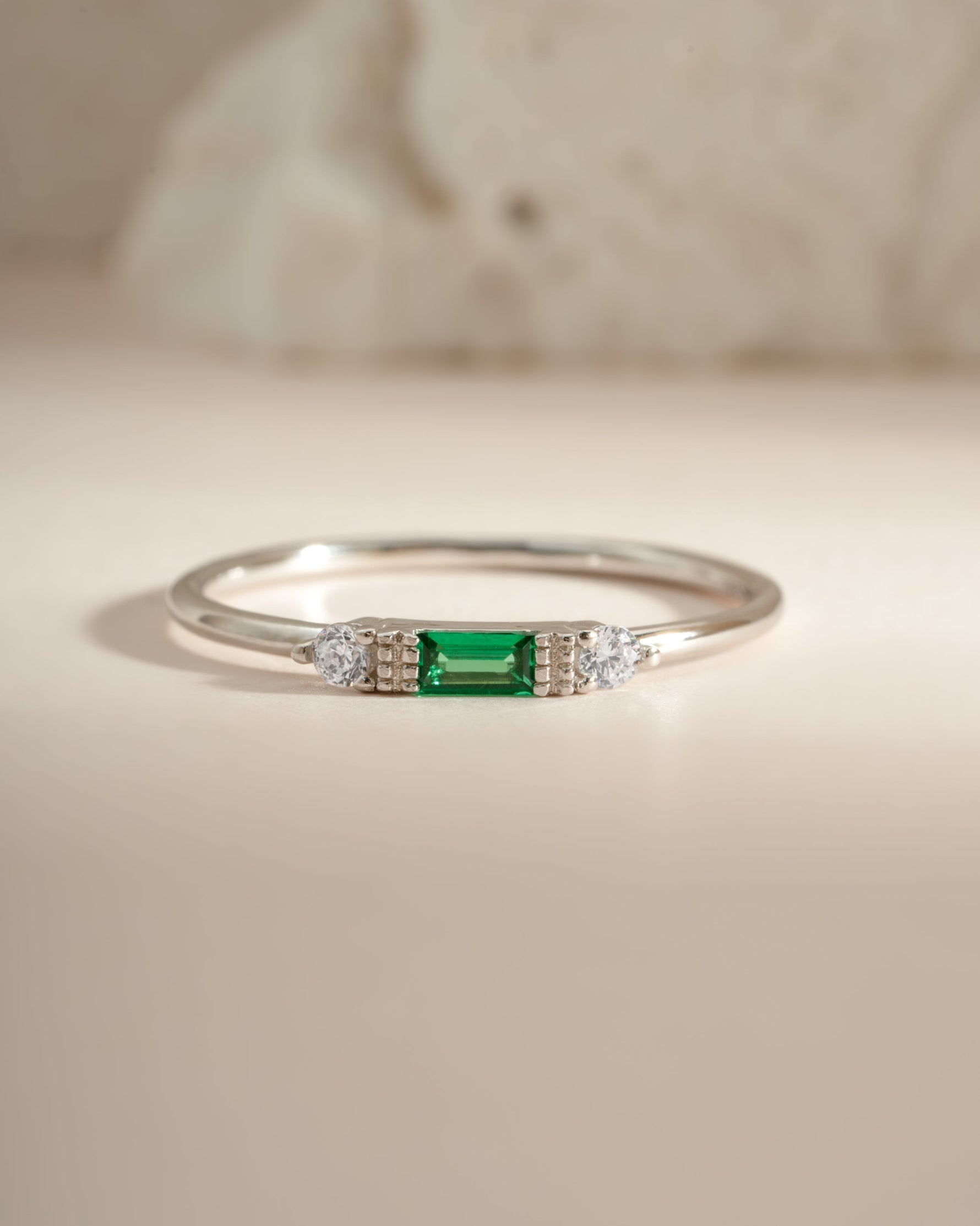 Sterling silver emerald baguette ring by Sami Jewels featuring a rectangular emerald gemstone set in a sleek band.
