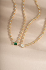 Emerald Baguette Tennis Necklace by Sami Jewels featuring emerald and white cubic zirconia stones on a delicate chain.