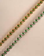 Detail of round green bezel settings on emerald tennis bracelet, view 7