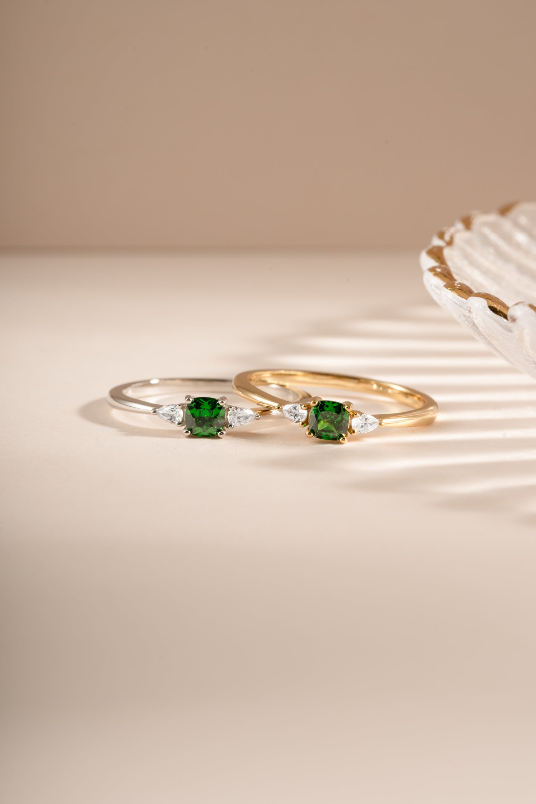Emerald cushion ring by Sami Jewels featuring a gold and sterling silver band with a vibrant emerald gemstone.