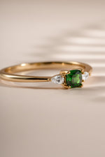 Close-up of Sami Jewels emerald cushion ring in gold, showcasing the vibrant green emerald gemstone and elegant band design.