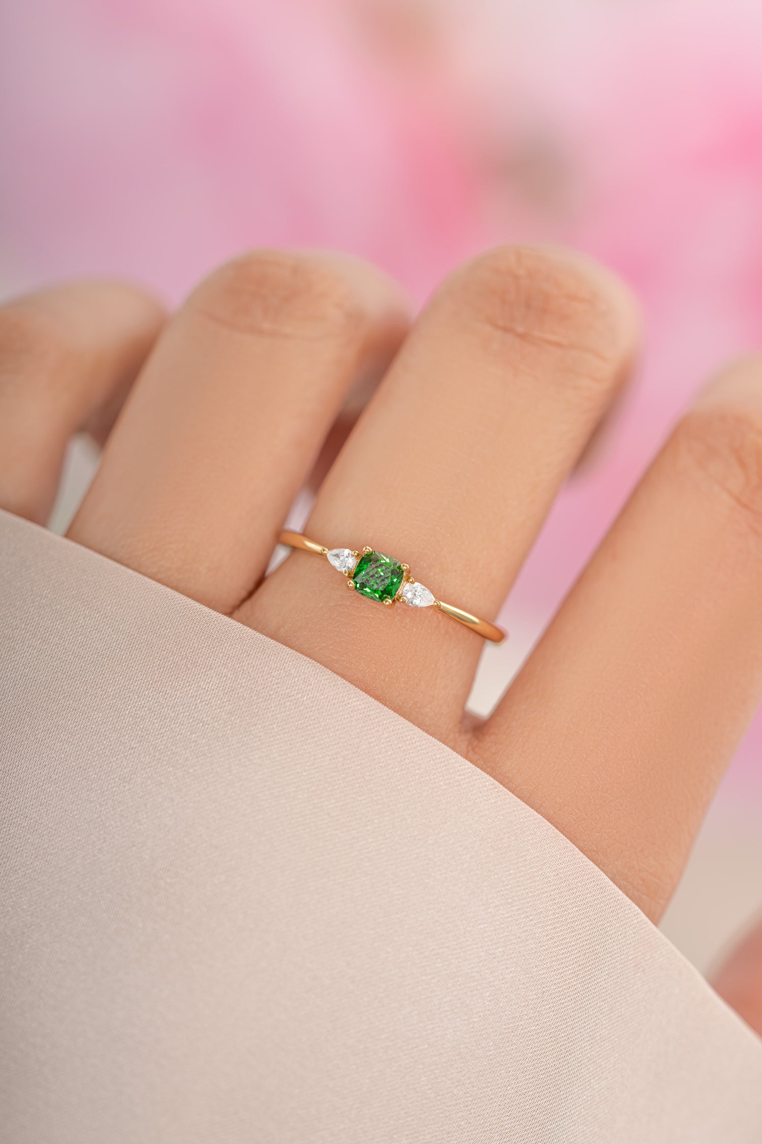 Gold Sami Jewels emerald cushion ring featuring a vibrant green emerald gemstone set in a polished gold band.