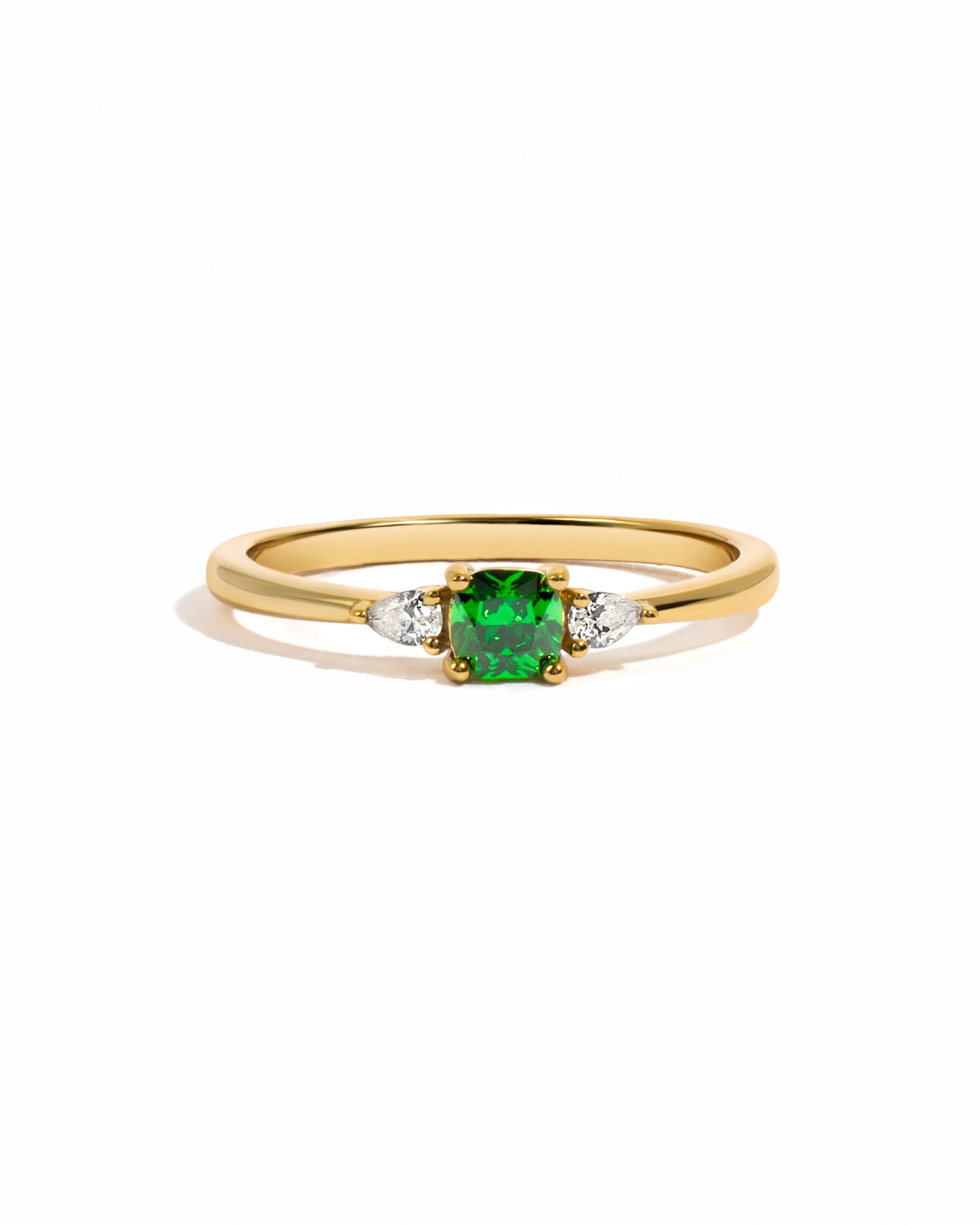 Gold emerald cushion ring by Sami Jewels featuring a vibrant green emerald gemstone on a sleek band.