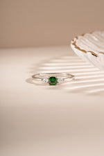 Sami Jewels emerald cushion ring featuring a sparkling green emerald gemstone set in sterling silver.