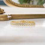 Gold emerald-cut bezel tennis bracelet by Sami Jewels featuring a sleek, elegant design with sparkling gemstones.