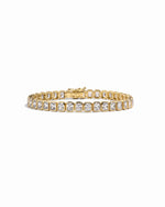 Gold emerald-cut bezel tennis bracelet by Sami Jewels displayed on a white background with detailed close-up of the bracelet design.