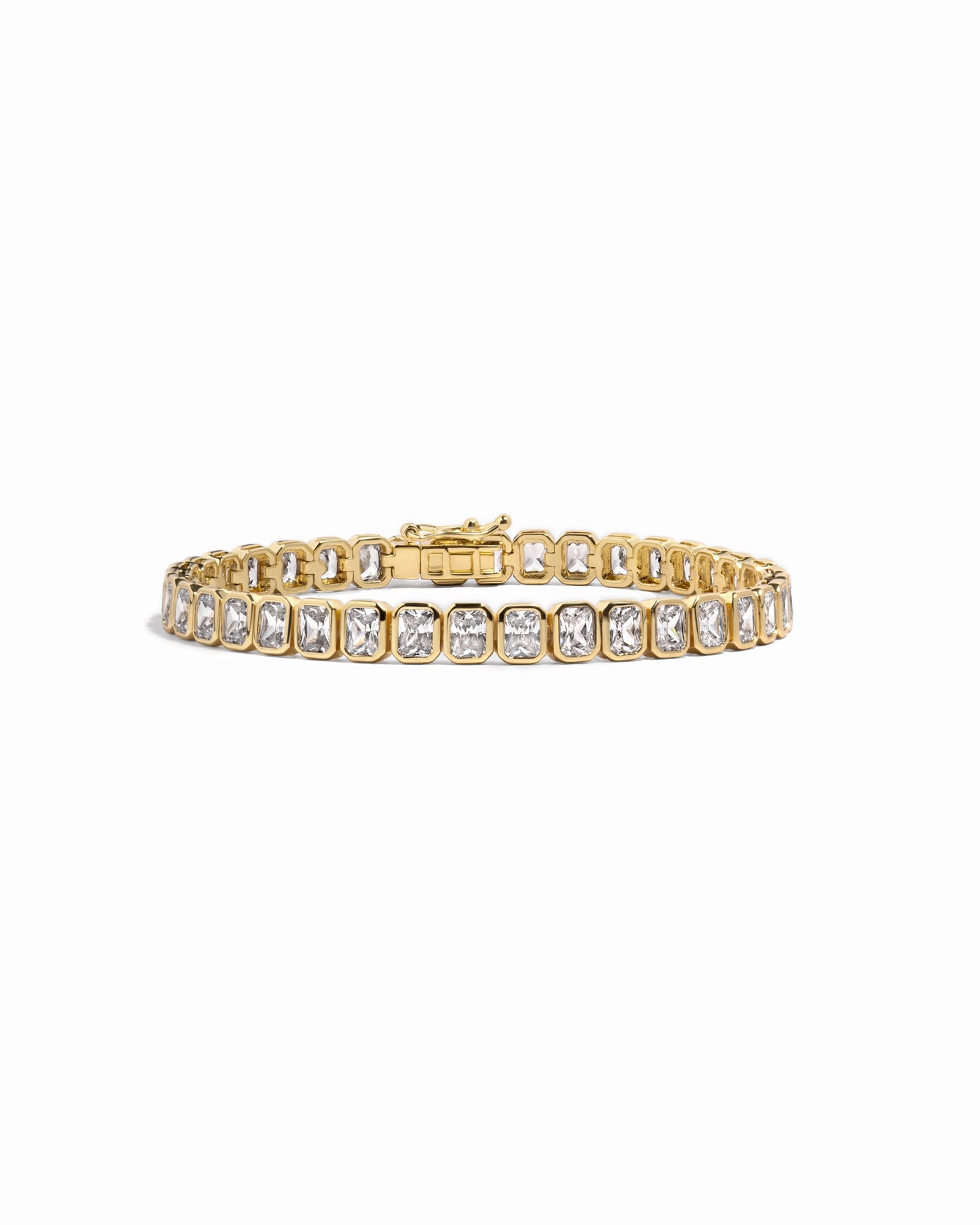 Gold emerald-cut bezel tennis bracelet by Sami Jewels displayed on a white background with detailed close-up of the bracelet design.