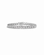 Silver emerald-cut bezel tennis bracelet by Sami Jewels displayed on a white background.