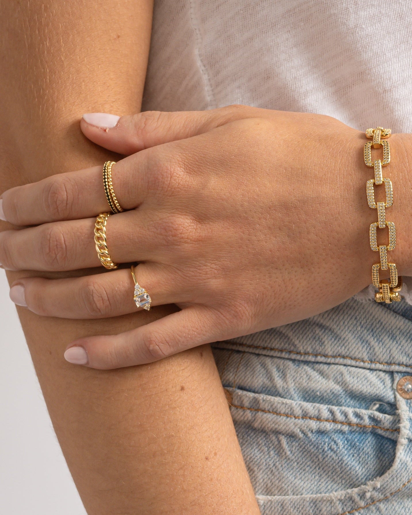Elegant emerald cut diamond stacking ring by Sami Jewels, featuring a gold band and a sparkling emerald-cut diamond.