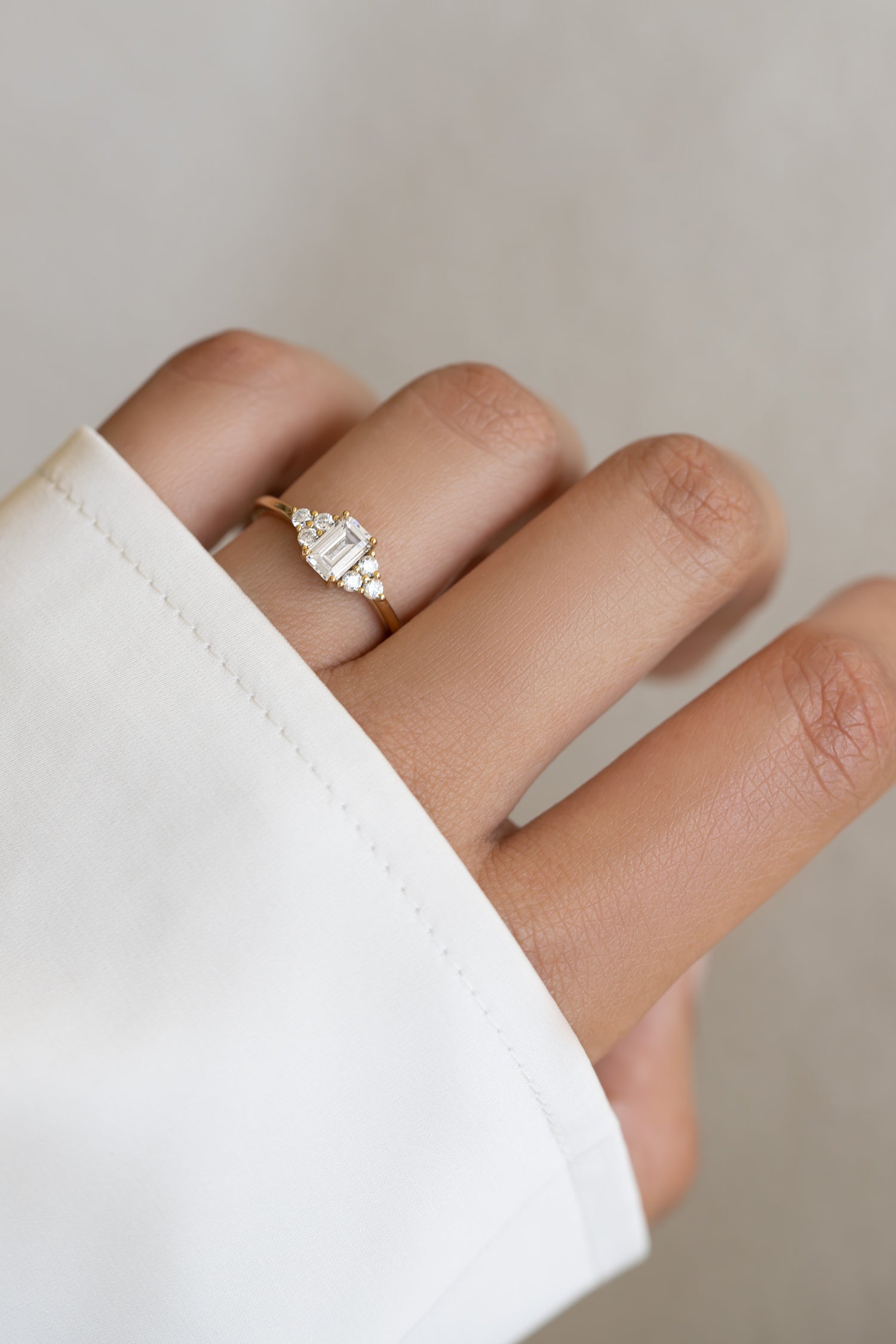 Gold emerald-cut diamond stacking ring by Sami Jewels featuring a sleek, elegant design with a prominent emerald-cut gemstone.