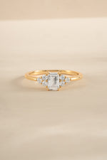 Elegant gold stacking ring with emerald-cut diamond, crafted by Sami Jewels, showcasing a sleek and sophisticated jewelry design.