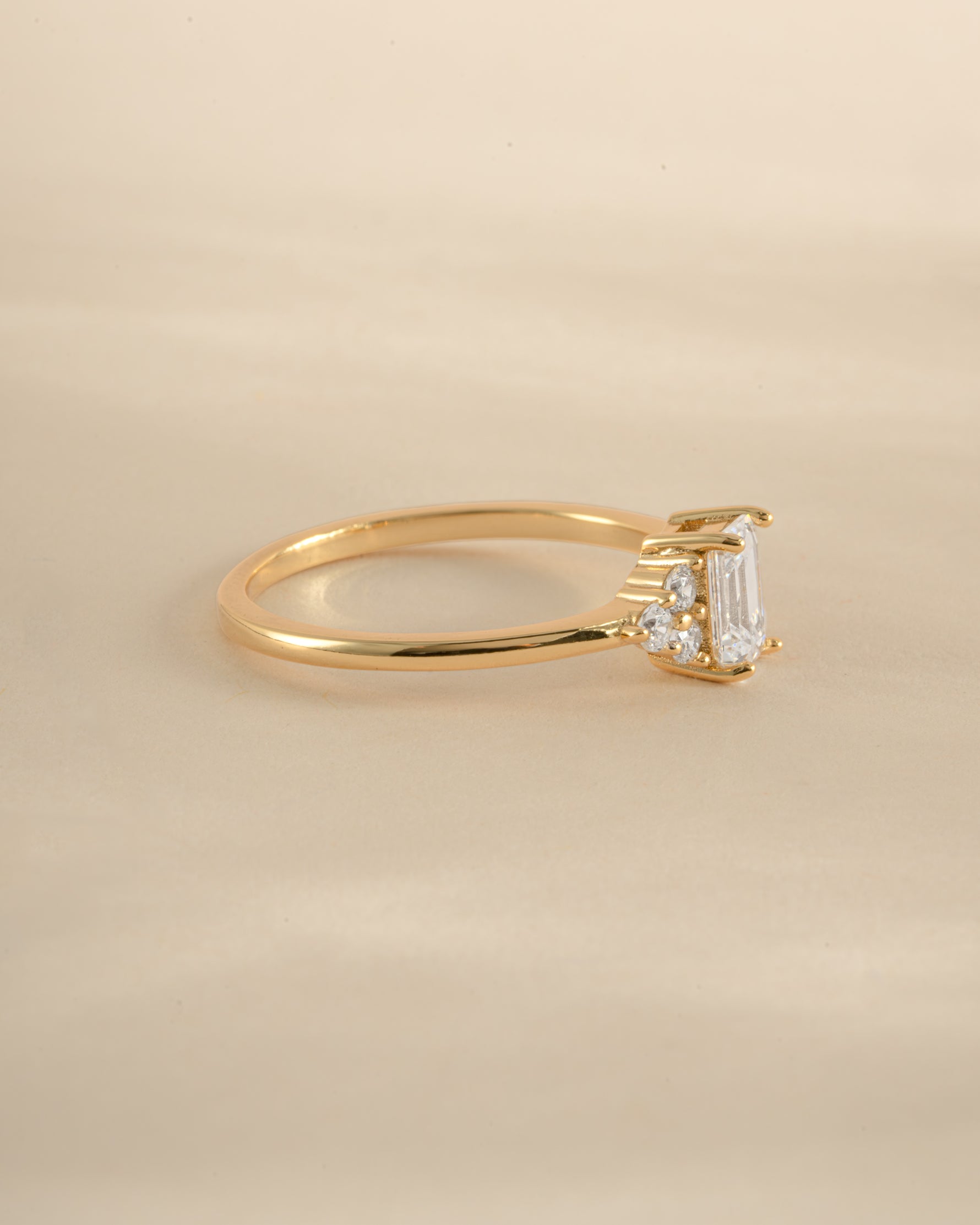 Gold emerald cut diamond stacking ring by Sami Jewels, side view showcasing the elegant gemstone and sleek band design.