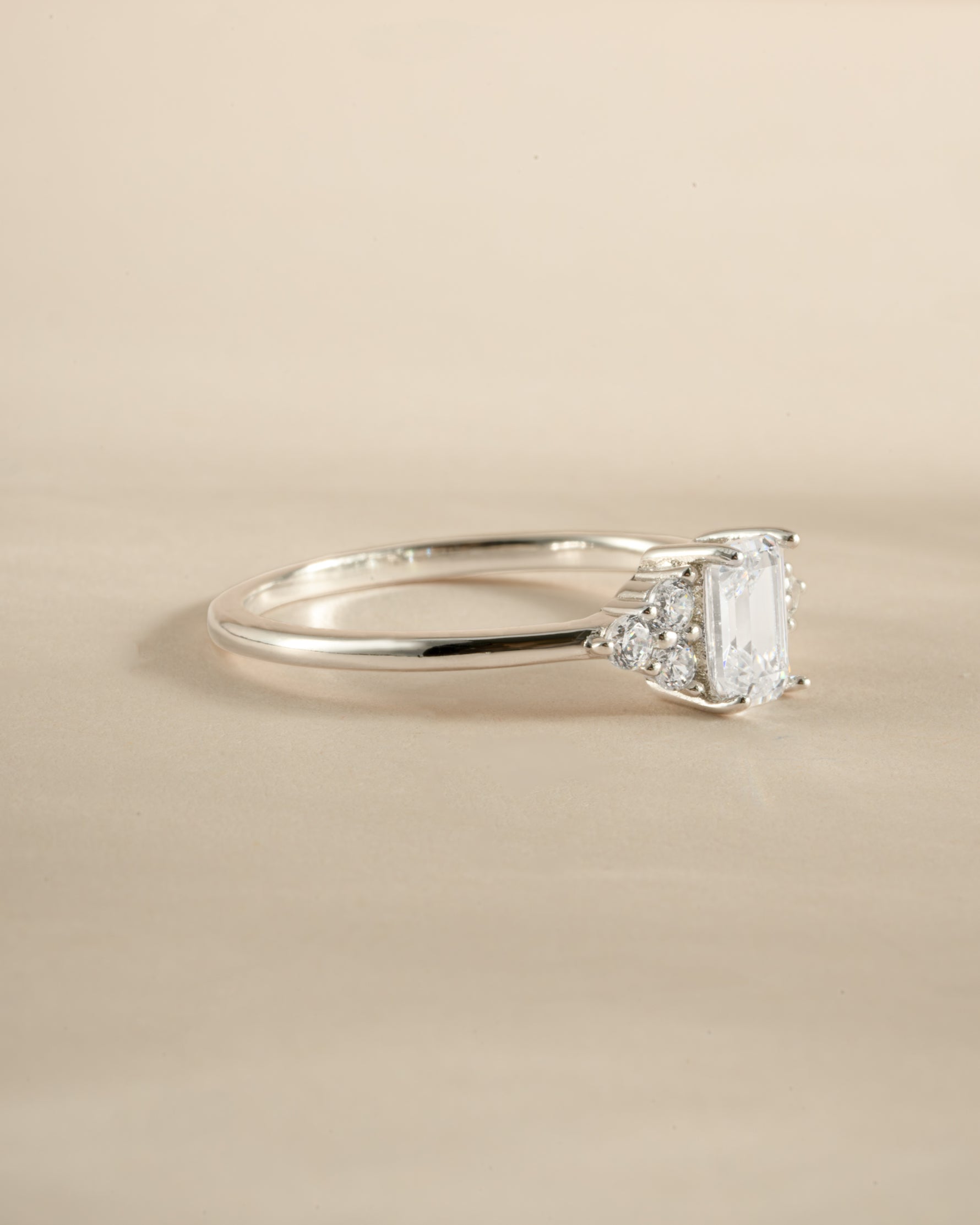 Sterling silver emerald cut diamond stacking ring by Sami Jewels, side view showing sleek design and sparkling gemstone.