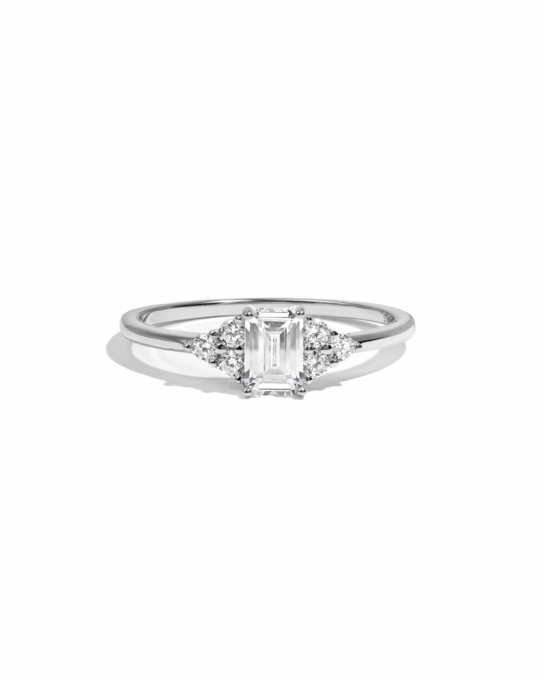 Sterling silver Sami Jewels emerald cut stacking ring with a central diamond-shaped gemstone on a white background.