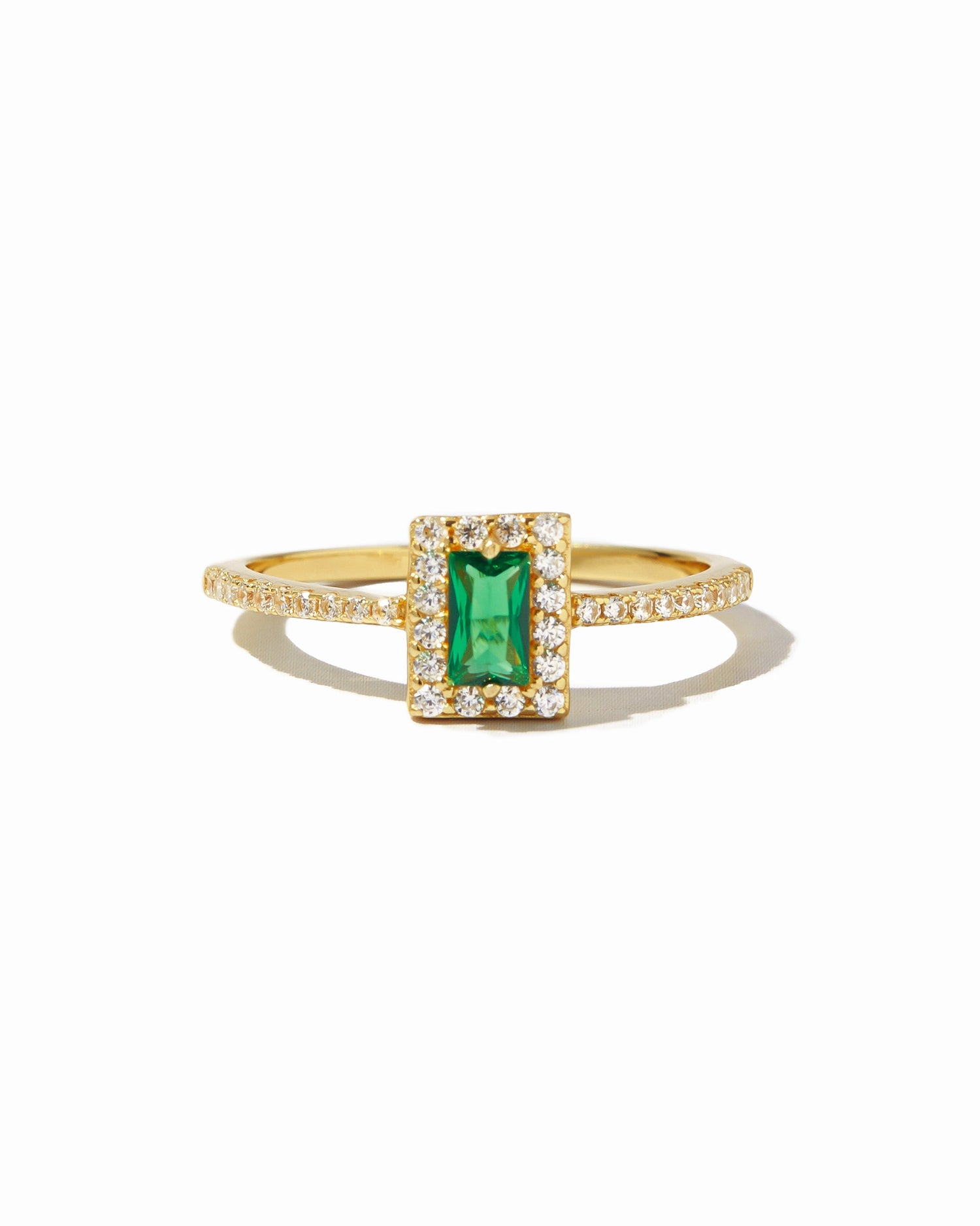 Sami Jewels emerald-cut CZ ring featuring a vibrant green gemstone set in a gold band on a white background.