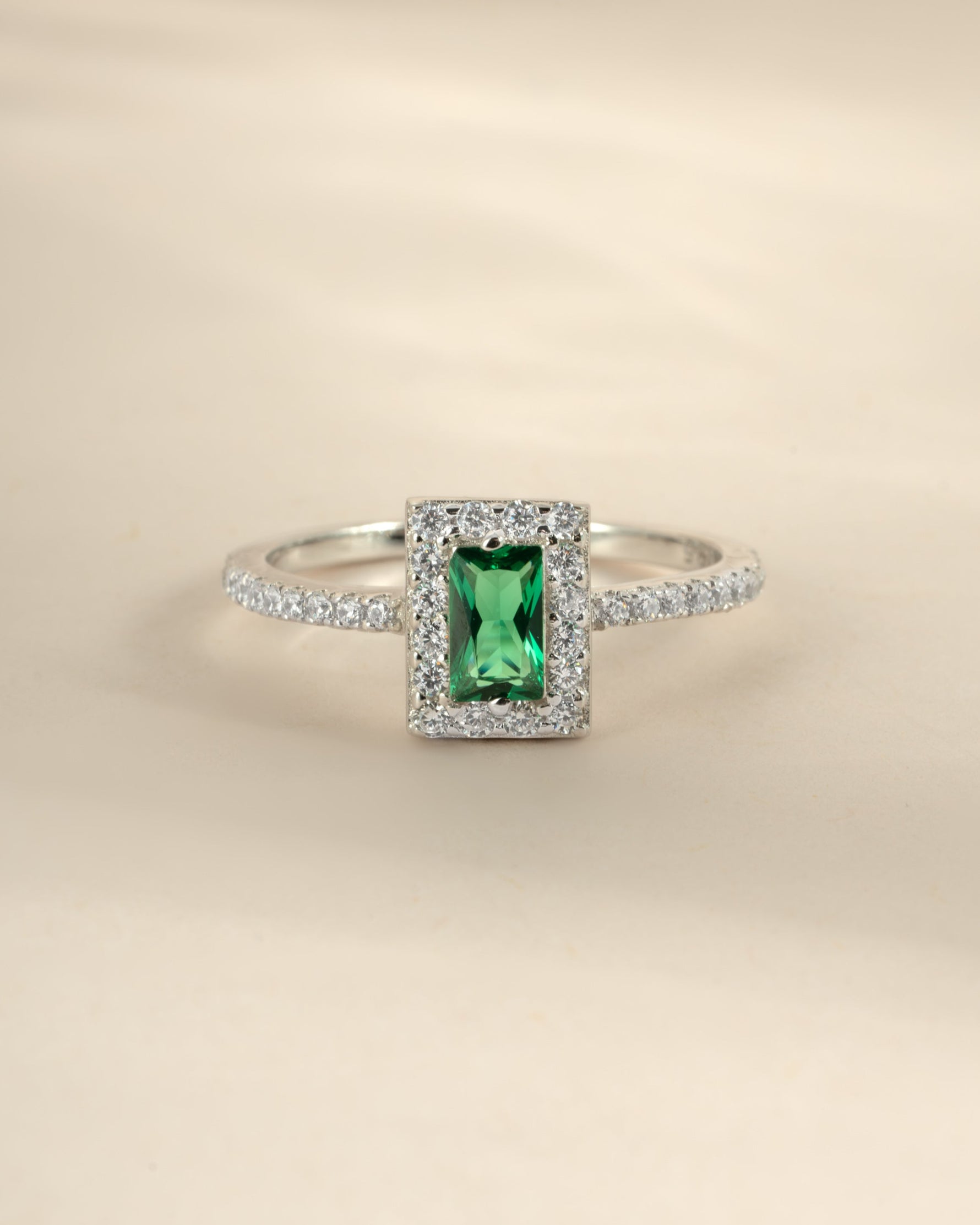 Close-up of Sami Jewels Emerald CZ ring featuring an emerald-cut green cubic zirconia set in sterling silver.