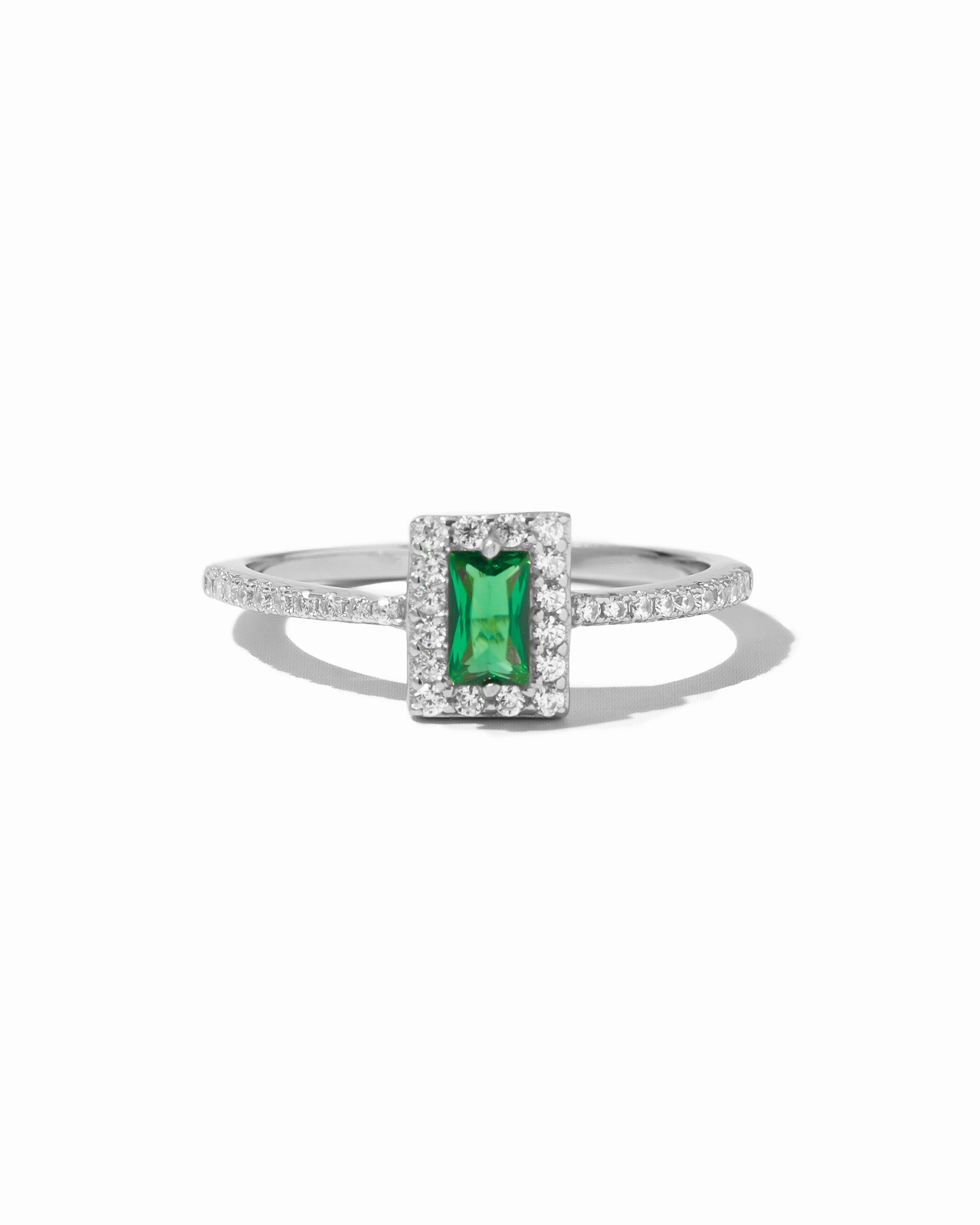 Sterling silver emerald-cut CZ ring by Sami Jewels, featuring a vibrant green gemstone on a white background.